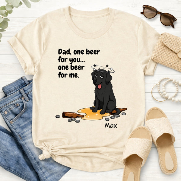 A cream-colored graphic t-shirt styled in a flat lay with blue jeans, beige slides...on a white wood background. The t-shirt features a custom cartoon dog wearing a halo and a beer glass, with the text 'Dad, one beer for you.... one beer for me'